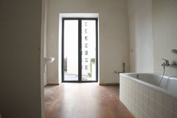 Afgewerkte badkamer met ligbad en dubbele wastafels en toilet