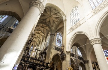 De bogen aan het plafond van de zuidzijde van de kerk zijn gerestaureerd en wit geschilderd, die van de oostzijde nog niet.